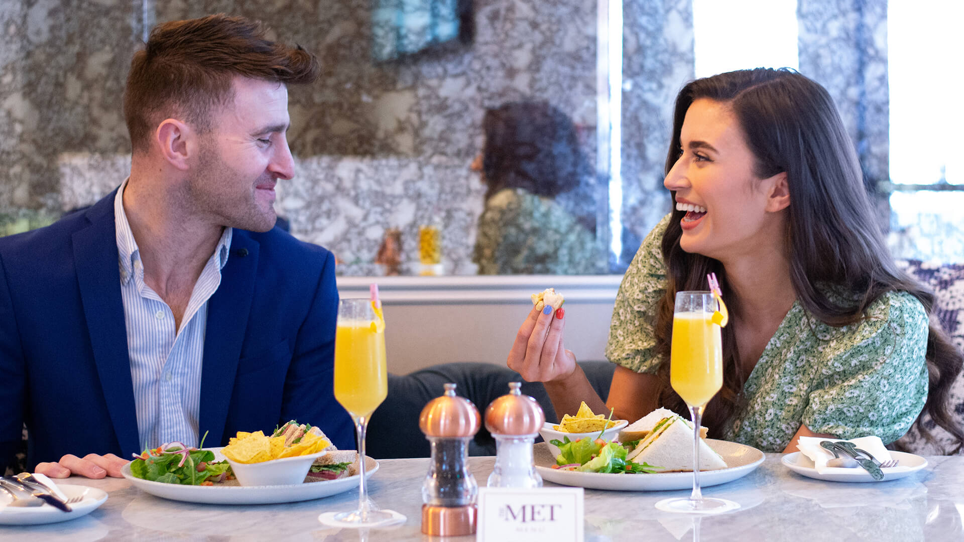 Couple laughing enjoying brunch at The Metropole Hotel