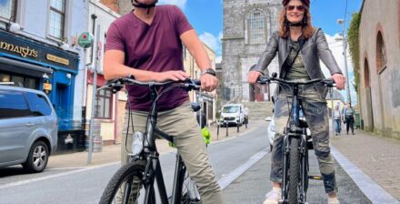 Cycling tour in Cork city with two cyclists enjoying the scenes