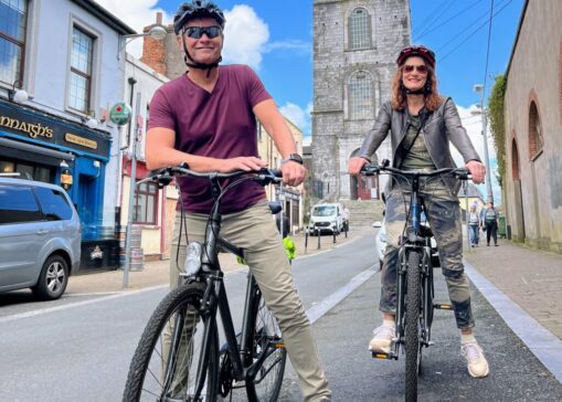 Cycling tour in Cork city with two cyclists enjoying the scenes