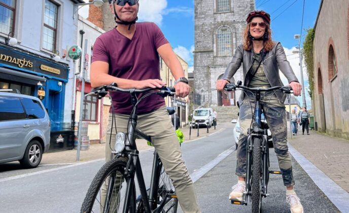 Cycling tour in Cork city with two cyclists enjoying the scenes